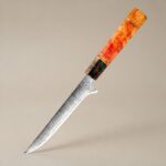 Close-up of Monarch Professional Boning Knife blade highlighting razor sharp edge and high quality steel craftsmanship with detailed texture