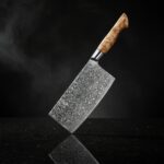 Close-up of the Monarch Cutlery Chinese chef cleaver knife showing the full tang blade, sharp cutting edge, and wooden handle.