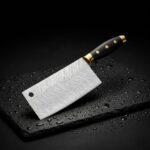 Close-up of the Monarch Cutlery Japanese cleaver chef knife showing the sharp polished blade and ergonomic wooden handle.